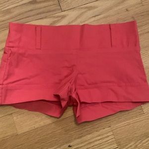 Body central shorts. Size small. Pinkish red color.